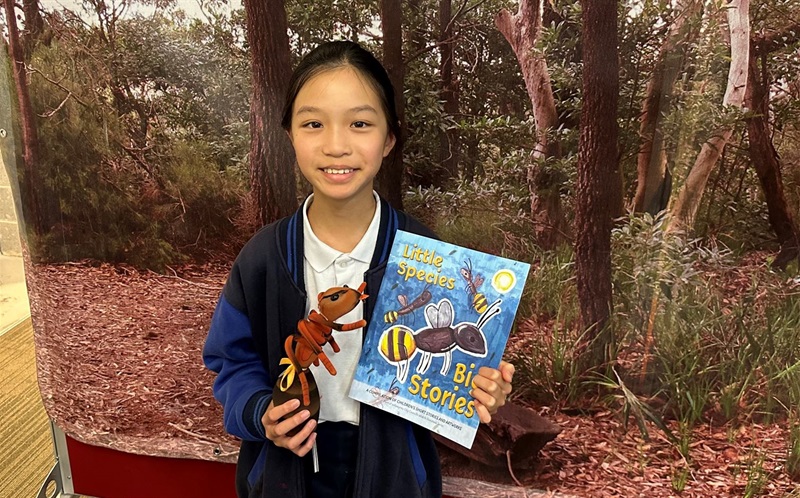 Olivia from Castle Cove Public School with her Golden-tailed Spiny Ant artwork that was selected for the front cover.jpg
