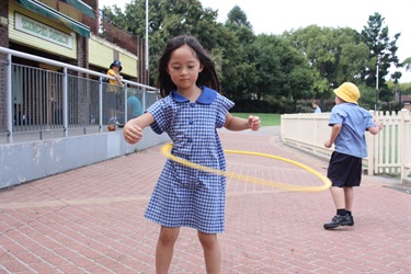 Girl with hula hoop at Chatswood Oval