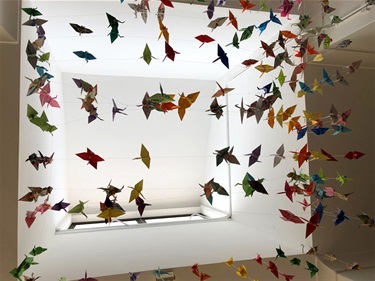 Paper cranes hanging from ceiling at Devonshire Children's Centre